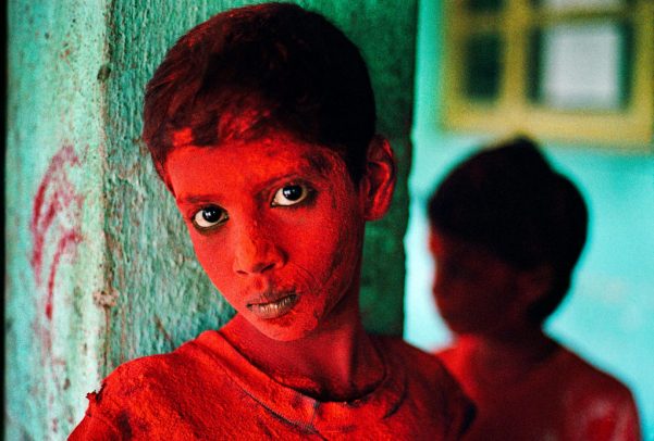 Boy covered in red powder