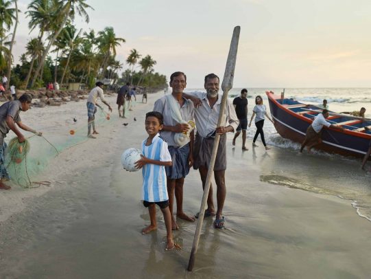 Two men and a child on the beach for Kerala Tourism Campaign by Joey L. 