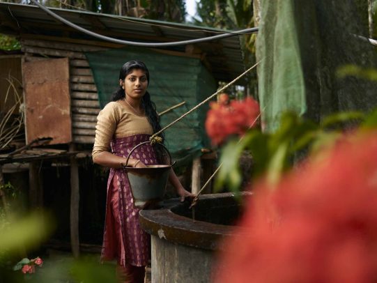 girl at a well for water