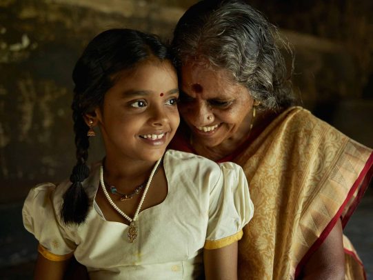 grandmother and granddaughter smiling