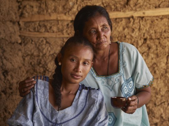 Grandmother hugging her granddaughter and holding a cup of coffee for Lavazza Calendar 2016 by Joey L