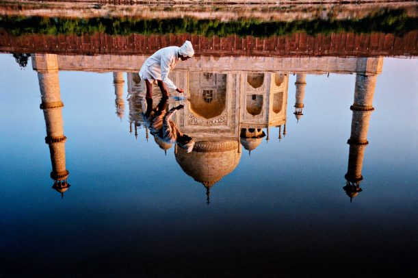 Man and taj reflection