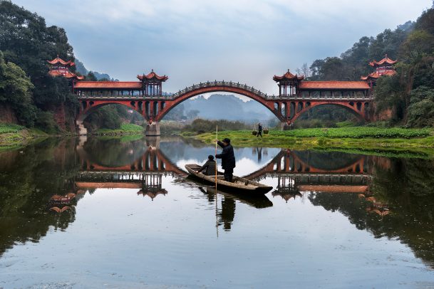 Two men on a boat on a river