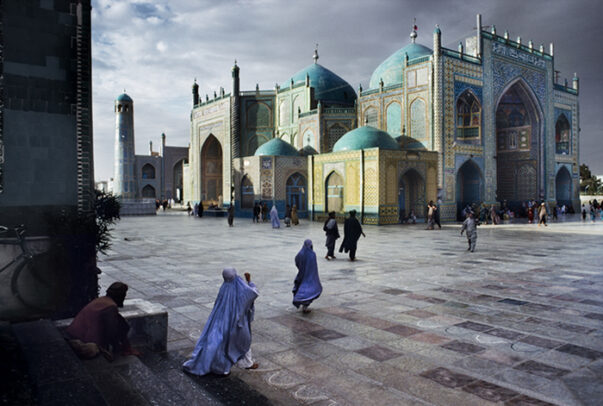 women in burqa walking in the square of Hazrat Ali Mosque