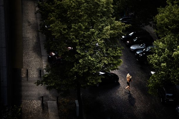 a woman running in high heels in the street