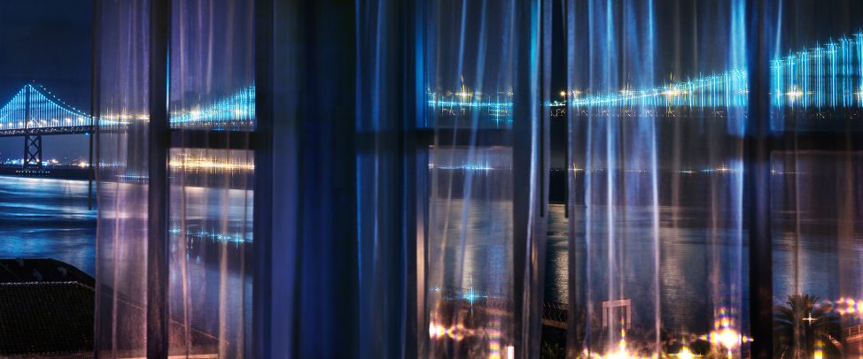 san francisco bridge at night behind a curtain
