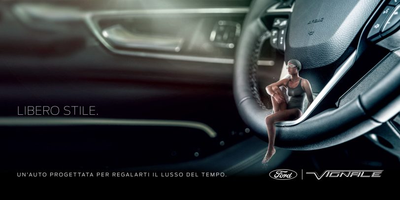 little woman sitting on the steering wheel