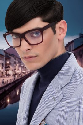 man wearing black glasses with Navigli in Milan on the background