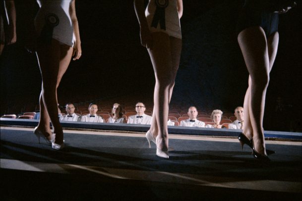 legs of three girl while a jury watch them