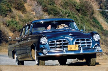 woman with a lion in a fifties blue car