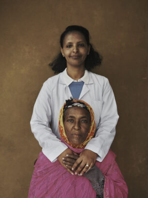 A doctor hugging her patient for Novartis annual report by Joey L. 