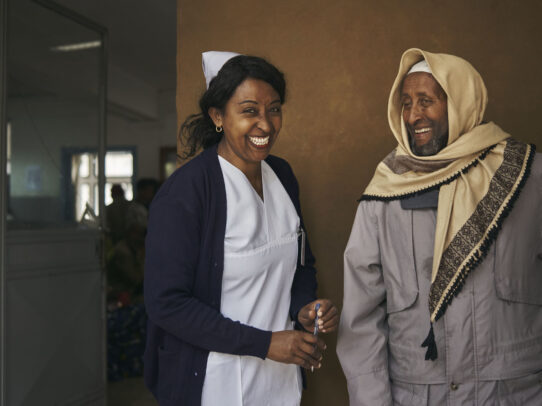 a nurse smiling and a man with veil