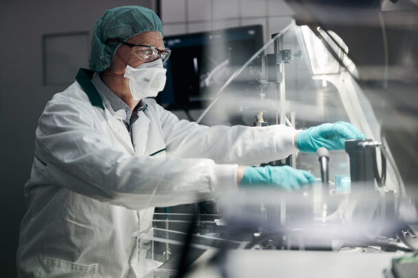 a doctor with mask, cap and gloves in laboratory during Novartis annual report by Joey L. 