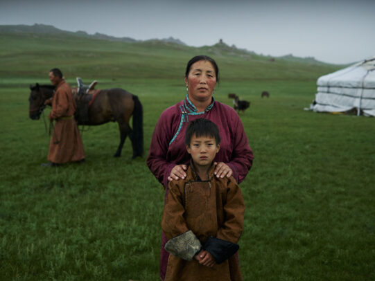 a mongolian woman and a child posing for Novartis annual report by Joey L. 