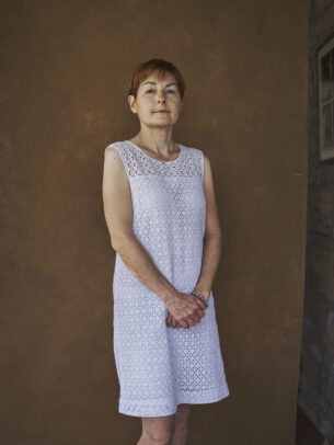 a woman with a white dress posing for Novartis annual report by Joey L. 