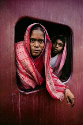 woman and child looking outside a window train in Calcutta