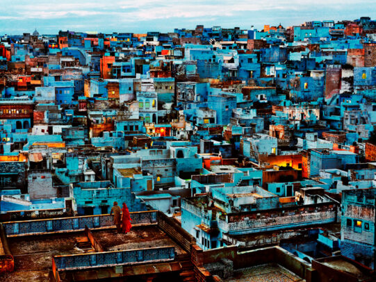 Couple looking over balcony at the vibrant city of Jodhpur