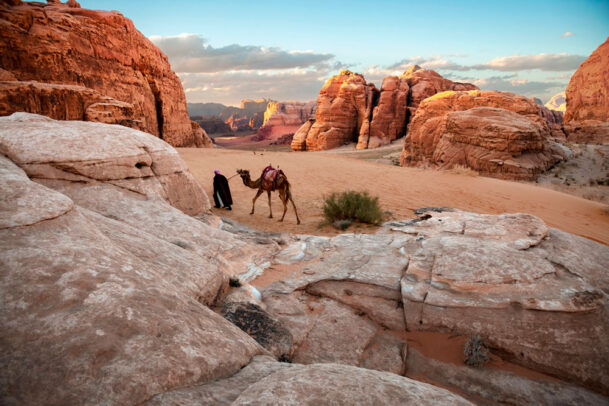 man walking with his camel in Wadi Rum