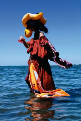 Model with red dress in water
