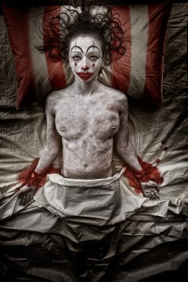horror clown with wrists slashed