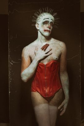 clown in corsage with needles on head