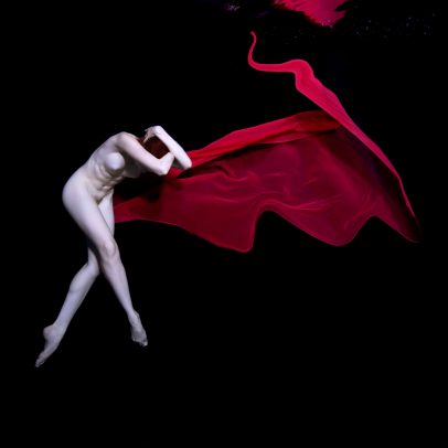 girl with red fabric underwater