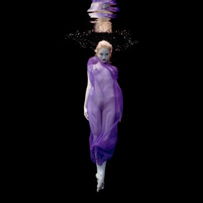 blonde girl underwater with purple dress