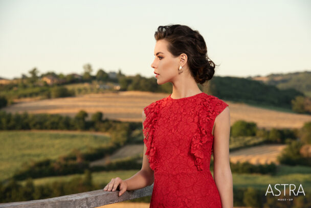 a girl with red dress and in background italian countryside for Astra Make Up by Susi Belianska