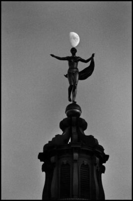 statue and the moon on background
