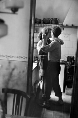 Photographer Robert Frank dancing in the kitchen with his wife