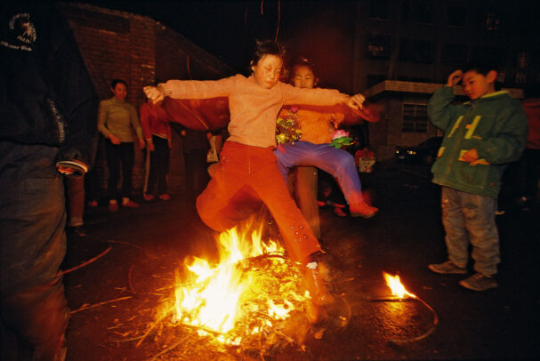 children jumping on the fire at the end of new years celebration