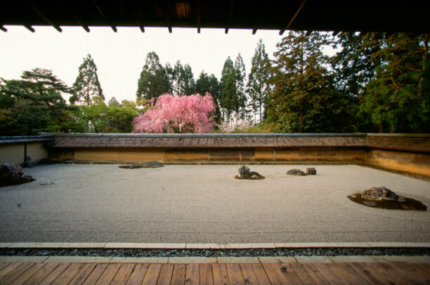 a japanese garden with rocks and sand