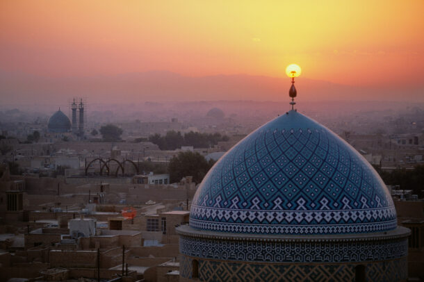 Sunset inflames the crescent symbol atop the dome of the Jame Masjid.