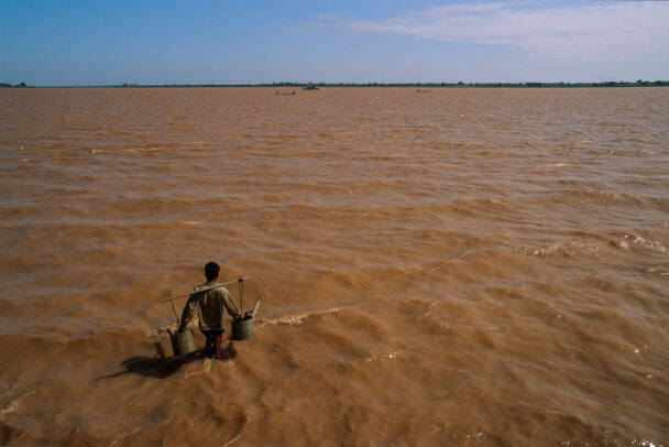 A farmer takes advantage of the flood-swollen Mekong outside Phnom Penh to fill his irrigation buckets