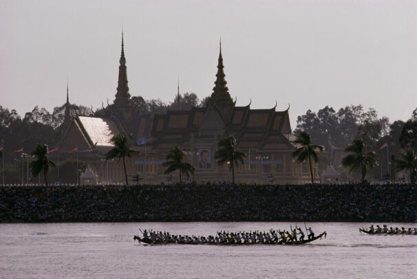 men competing in a pirogue races on Mekong River