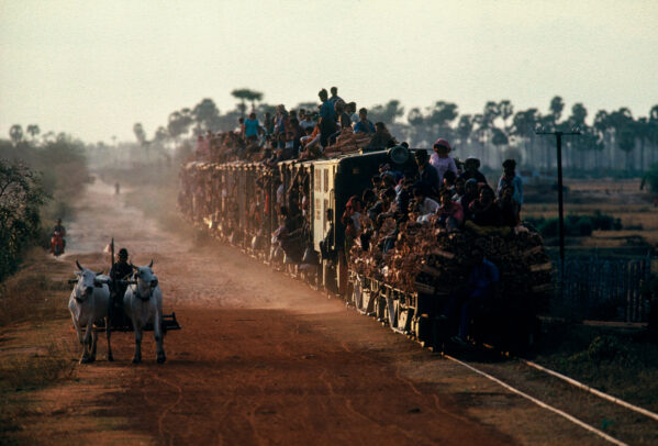 train overloaded with people on the top