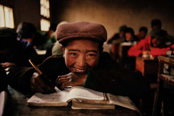 children smiling on the book in a classroom