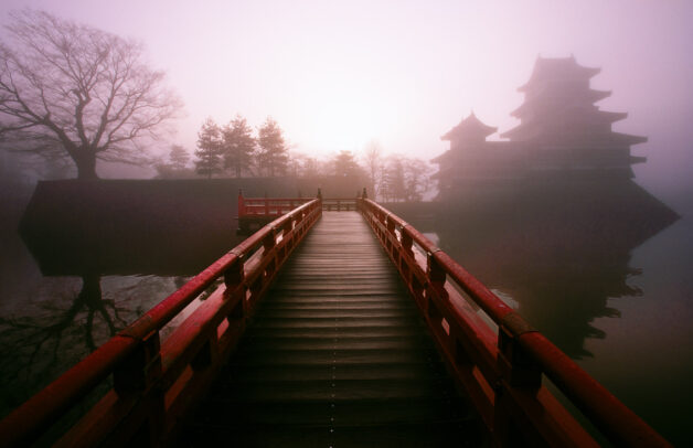 A bridge leading to a mist-veiled Castle in Matsumoto, one of the best preserved fortress from the samurai's reign.