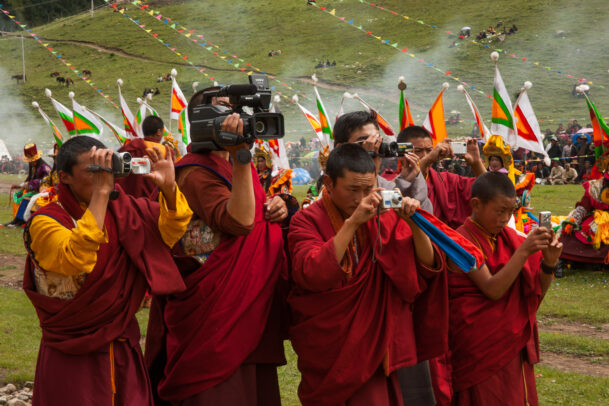 Shechen monks record an event with cameras and videocameras
