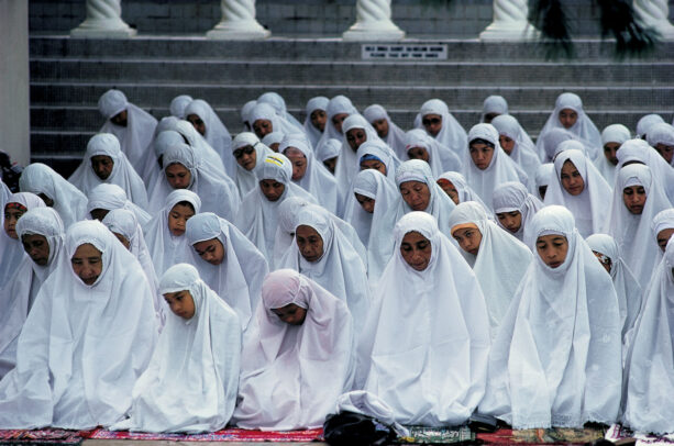 Women worshipers, in snow-white tudong