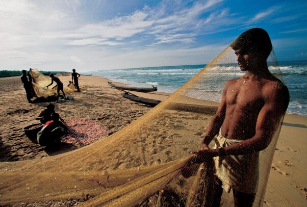 fishermen clean their nets on Somatheeram Beach